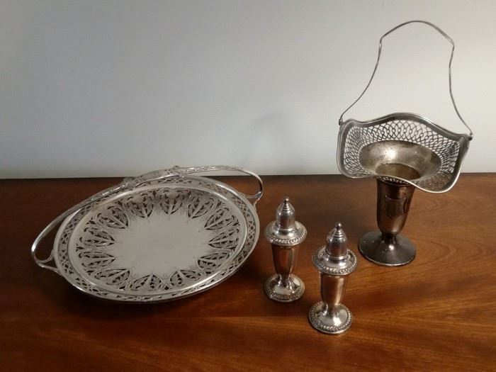 A pair of sterling silver salt/pepper shakers and two other sterling silver pieces.   All items made of precious metals are stored in a safe off site until the days of the sale.