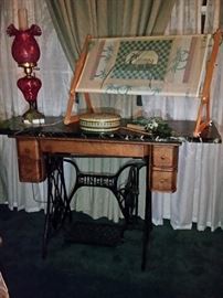 Old Singer sewing machine cabinet repurposed as a marble top table