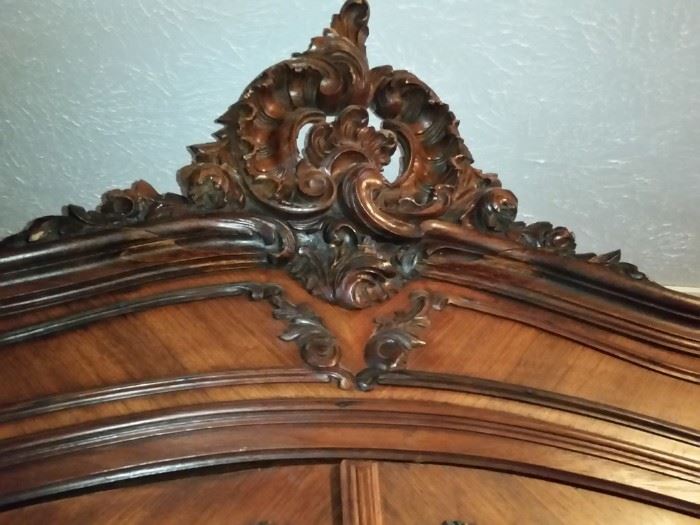 Carved mahogany top of the armoire