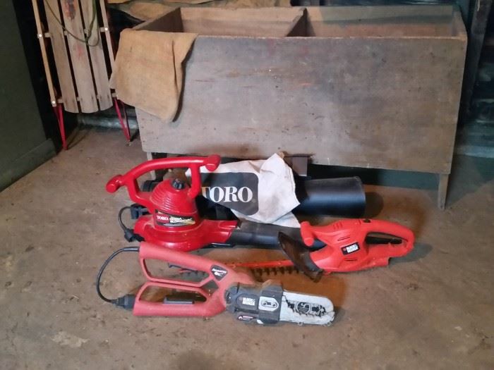 Vintage sled and large primitive grain bin.  Toro leaf blower/vac, Black & Decker hedge trimmer, and Black & Decker 'Alligator'