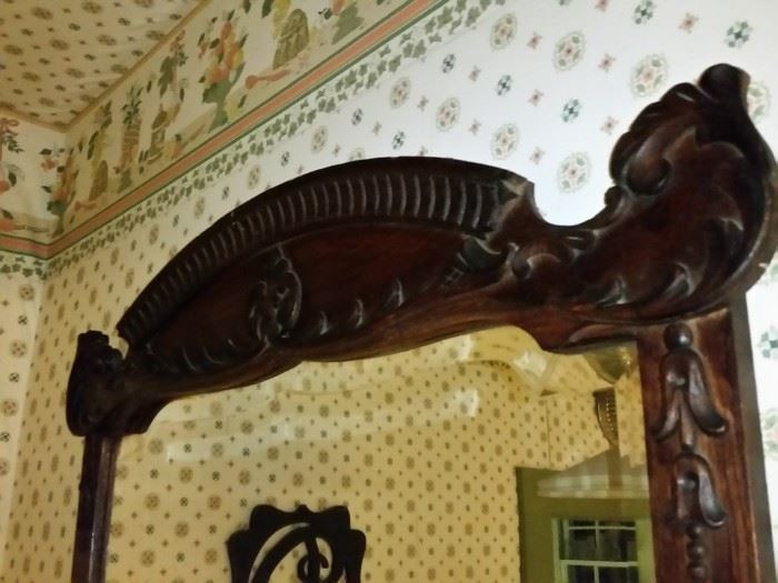A closer look at the carvings at the top of the mirror