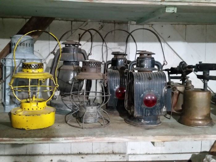 Nautical oil lantern, railroad lanterns, pair of Dietz buggy lanterns, and blow torches