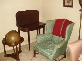 Globe on stand, mahogany game table, wing chair Pr.