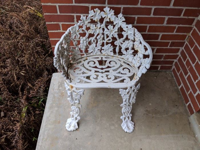 Cast iron chair. house on the hill.