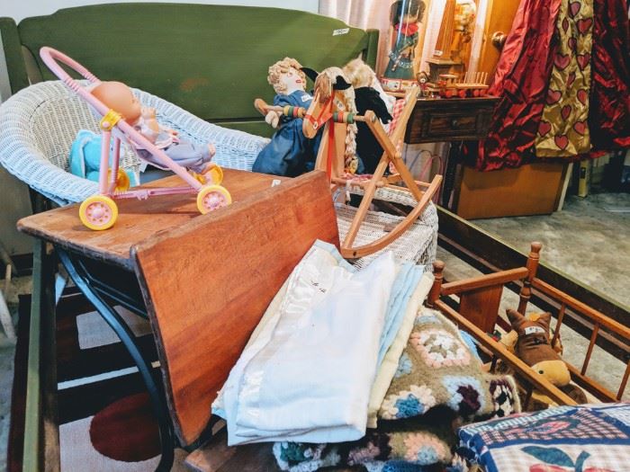 This is in the childs room. Vintage toys and dolls. This is an old school desk.