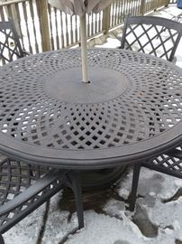 Lovely cast aluminum patio set with six chairs and umbrella