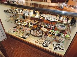 This case IS JAMMED FULL OF COSTUME...and it overflows on the top of the case and on necklace stands...