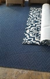 Several outdoor patio rugs