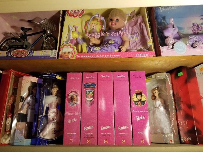 Collectible Barbies and Lila unicorn.