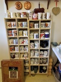 Antique copper lids and dust pan, spice racks (no spices), and mugs.