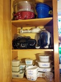 Pyrex and vintage glass refrigerator boxes, Corning casserole dishes, and small kitchen appliances
