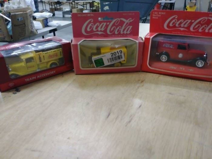 Three Coca Cola Matchbox cars listed in descripti ...