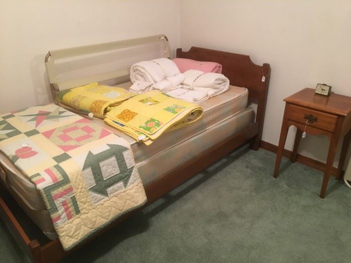 Maple Twin Bed and side table. Several of the available quilts shown in this photo