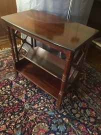 Antique mahogany end table with book rack