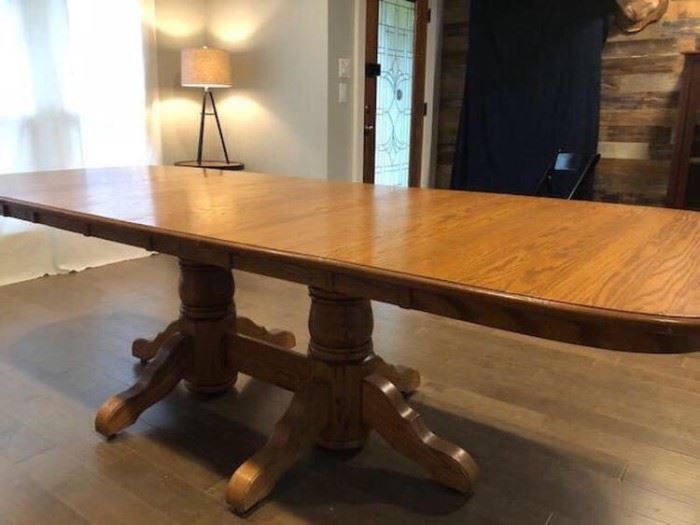 Oak pedestal table shown with all leaves
