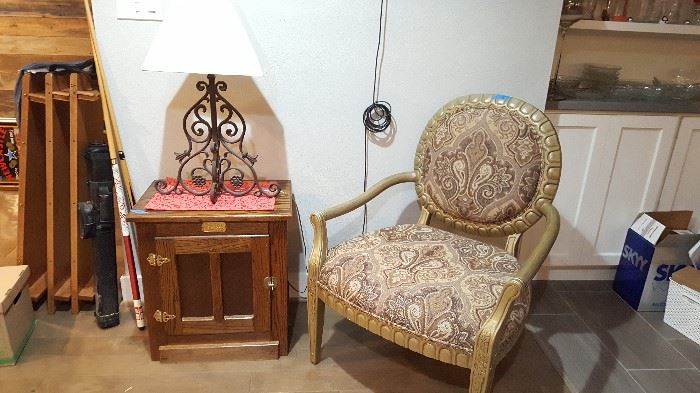 upholstered armchair & oak cabinet, heavy metal scroll lamp