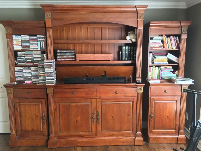 Wall unit with a powered TV lift. Bookcase ends can be purchased separately from the center piece. It is located on the second floor. It is HIGHLY encouraged to bring professional movers. Blue Moon cannot assist moving.