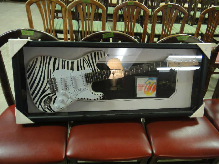 Autographed guitar with certificate of authenticity. Signed by Mick Jagger & Keith Richards of the Rolling Stones. This is beautifully framed and is sure to enhance any collection. There is a $2000 reserve on this piece.