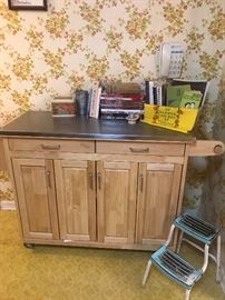 Kitchen island with stainless top and drop leaf side.