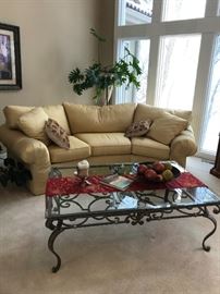 CONVERSATION SOFA AND WHIMSICAL WROUGHT IRON COFFEE TABLE WITH BEVELED GLASS TOP