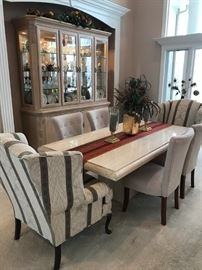 MODERNIST PEDESTAL MARBLE DINING TABLE WITH A PAIR OF WINGBACK END CHAIRS AND FOUR TUFTED BACK DINING CHAIRS