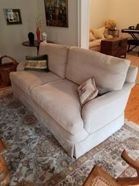 Pair of R. Jones sofas, handwoven rug