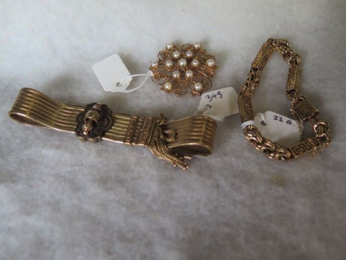 gold bracelets and brooch