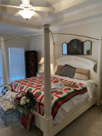 King size poster bed with handmade quilt and other bedroom decor and items.