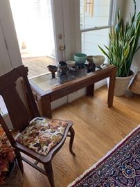 Long side tables, vintage chairs and pottery.