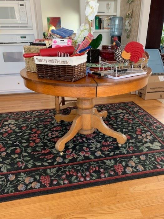 Beautiful vintage wooden circular kitchen table.  Miscellaneous decor and storage items.  Kitchen rug.