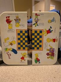 Collectible Simpsons chess table with chess set.