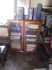 lots of  sheet  music  and   glass  front  cabinet,books