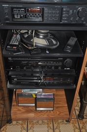Onkyo AM/FM and CD player with Yamaha amplifier, speakers and a collection of CDs in stereo cabinet 
