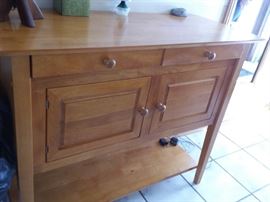 Sturdy wood cabinet with 2 drawers, large storage area and shelf.
