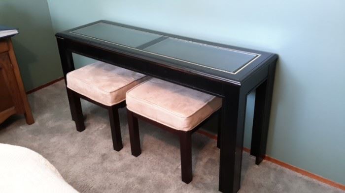 Glass top sofa table, black. 2 microfiber and dark brown wood stools.