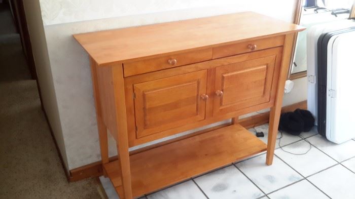 Sturdy wood cabinet with 2 drawers, large storage area and shelf.