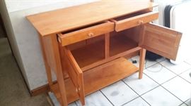 Sturdy wood cabinet with 2 drawers, large storage area and shelf.