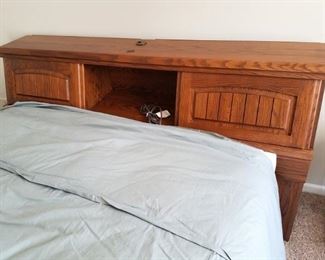 Full bed with lighted cabinet headboard