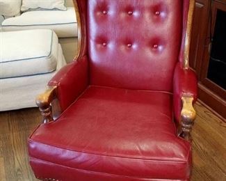 Red leather tufted wing back chair