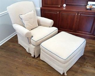 White chair and ottoman with light blue piping from Crate & Barrel