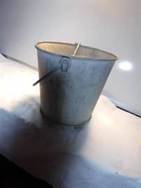 Metal bucket with fishing net