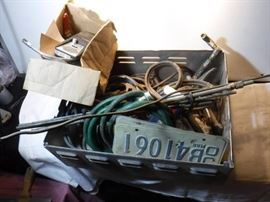 tote full of misc items including a hay hook