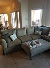 Large sage green sectional, ottoman in shades of blue and green