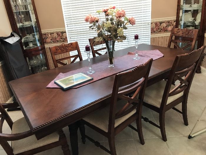 shown with six chairs and one leaf.  With the second leaf, this beautiful table measures 9' and seats  two armchairs and six side chairs. Cost over $4000 new