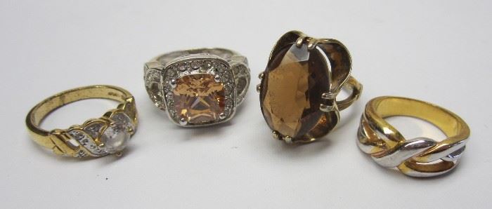 FOUR COSTUME RINGS
