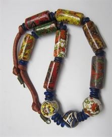 ETHNIC NECKLACE WITH HAND PAINTED PORCELAIN BEADS AND BLUE GLASS DISCS, STRUNG ON SILK COVERED ROPE