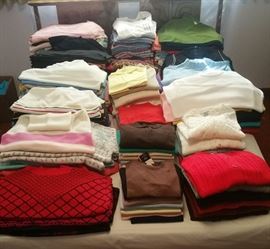 Stacks and stacks of vintage sweaters and tops. a LOT of these still have price tags attached. All were stored in plastic. Some were marked "washed but not worn". Size is mostly vintage medium and large.