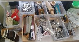 Lots of kitchen gadgets, super clean, many still packaged. A Corelle set peeks at the right there.