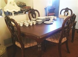 Beautiful dining room table has 2 leaves, 4 chairs.