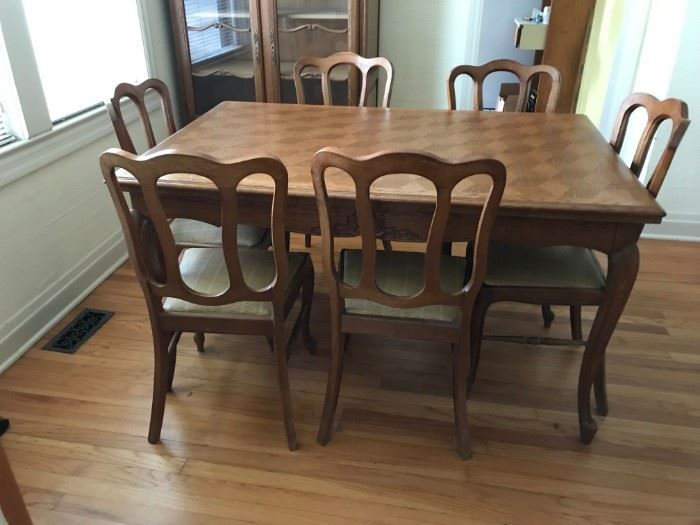 #2 dining table with geometric design on top 6 chairs and a leaf   $275.00